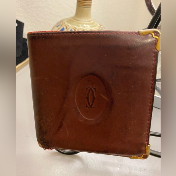 Cartier leather wallet. Embossed logo. Maroon ext., red interior. Metal corners. - Picture 1 of 4